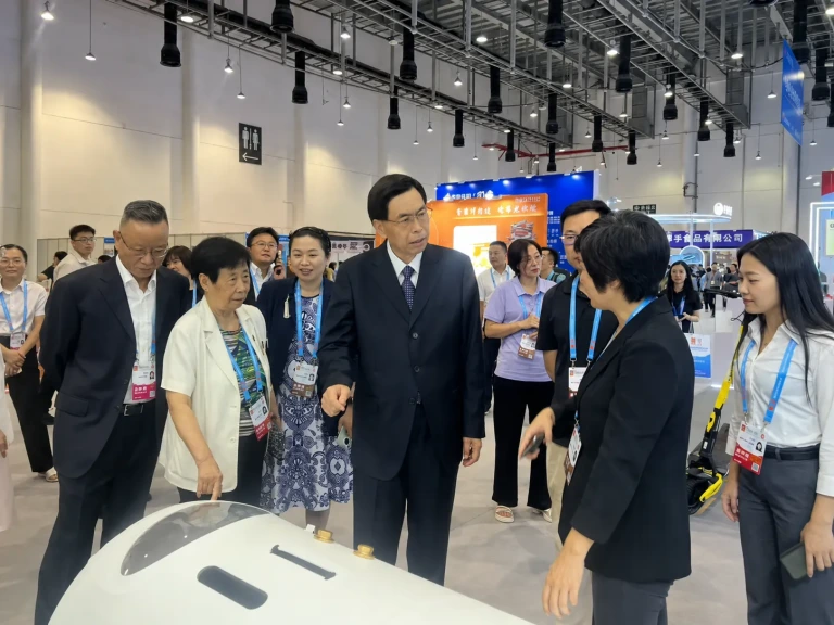 Visitors viewing a hyperbaric oxygen chamber at an exhibition