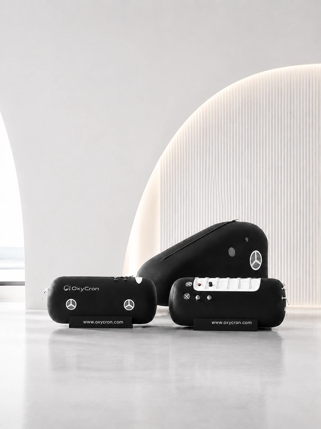 OxyCron black soft hyperbaric oxygen chambers displayed in a modern wellness showroom